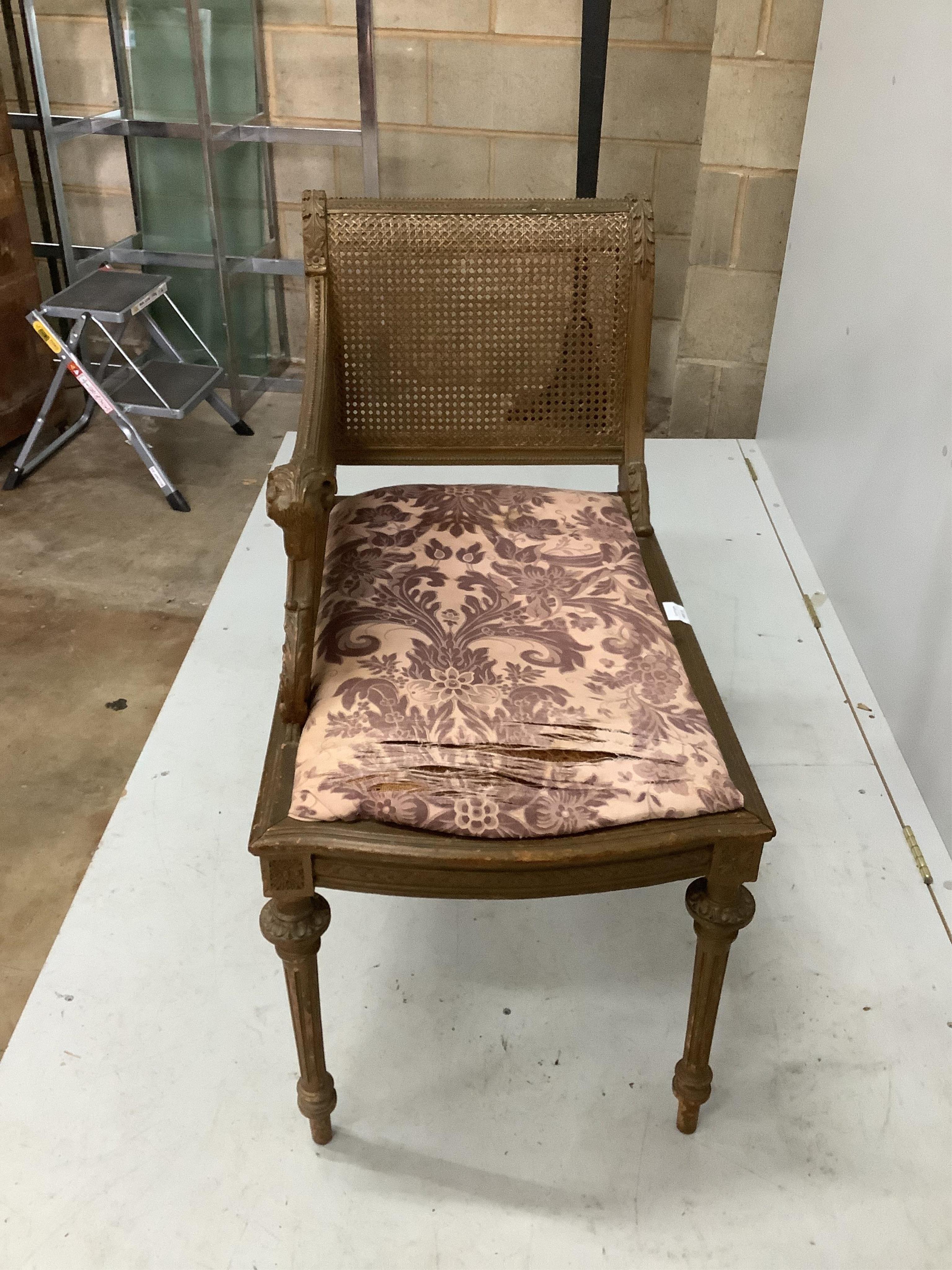 A Louis XVI style painted and giltwood caned seat, width 75cm, depth 44cm, height 84cm. Condition - fair